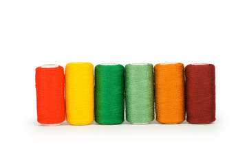 Row of colourful thread spools