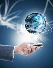 businessman holding mobile phone with globe