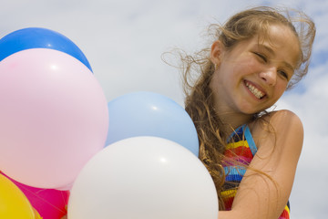 Fototapeta na wymiar Young girl with balloons