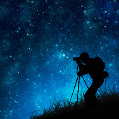silhouette of photographer shooting stars