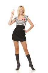 Fototapeta premium Full length of female showing victory sign