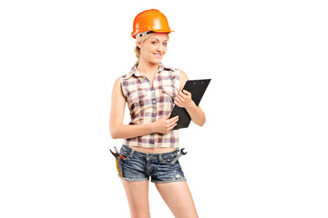 A female manual worker holding a clipboard
