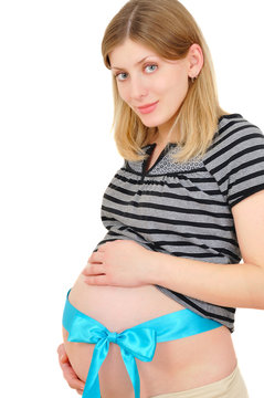 beautiful pregnant woman tenderly keeping her belly with nlue ri
