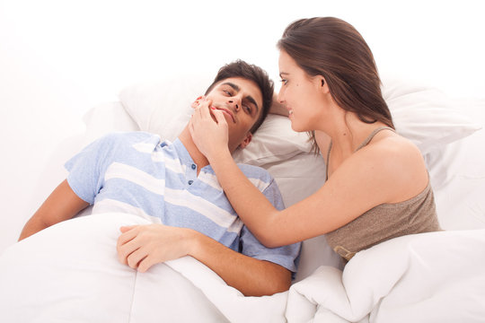 Portrait of a happy young couple relaxing on the bed