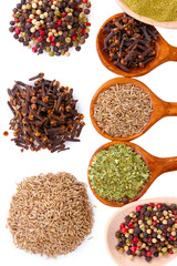 spices in the spoons isolated on white
