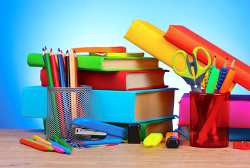 bright stationery and books on blue background