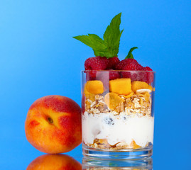 tasty cornflakes, fruit, milk in glass and mint