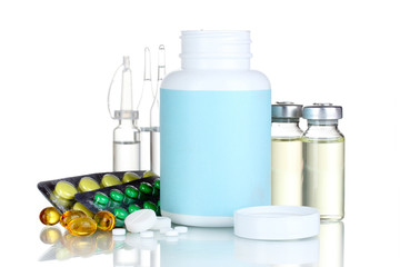 Medical bottles, ampoule and pills isolated on white