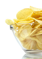 Delicious potato chips in bowl isolated on white