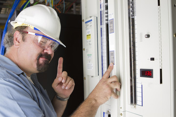 Engineer tries to remember voltage levels in-front of a panel.