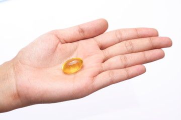 Cod Liver oil pill in hand isolated