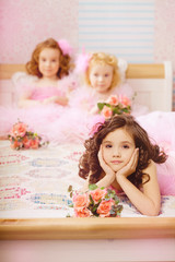Obraz na płótnie Canvas Children in the nursery in pink dresses