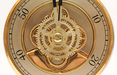 closeup golden clock with gears