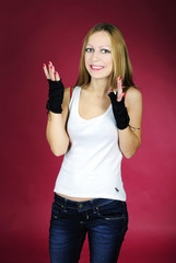 The young girl on a pink background in a white vest with the big