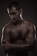 Fototapeta premium athletic young man with dewdrops on body