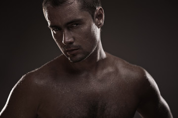 Fototapeta premium athletic young man with dewdrops on body