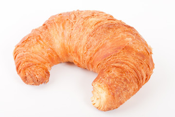 Fresh and tasty croissant over white background