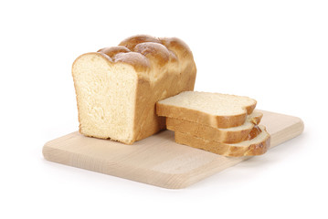 sliced loaf of bread on a cutting board isolated on white