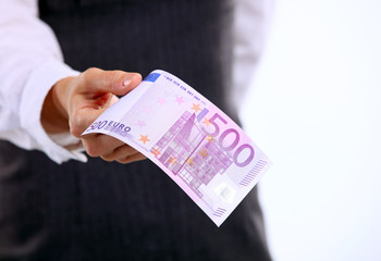 Female hand holding five hundred euro banknote