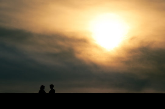 Silhouette of man and woman having conversation