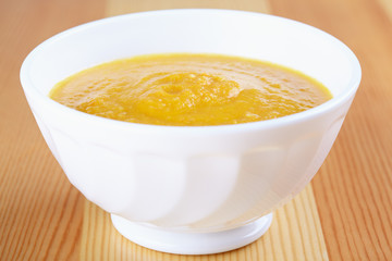 Pumpkin soup in white plate