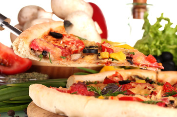 delicious pizza, vegetables, spices and oil isolated on white