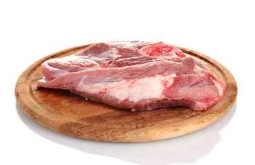 Raw meat on a wooden board isolated on white