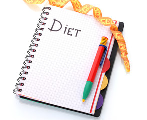 Planning of diet. Notebook measuring tape and pencil isolated