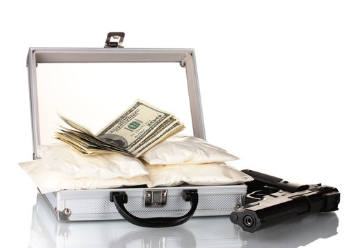 Cocaine with money and gun in a suitcase isolated on white