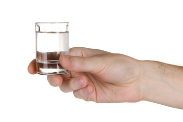 Man's hand holding a glass with vodka isolated on white