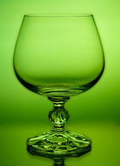 Abstract green wineglass and background