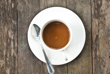 Coffee cup on the wood texture.