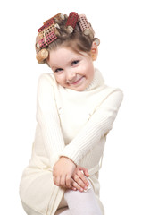 Beautiful little girl with curlers on her head.
