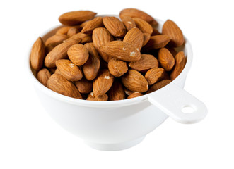 Raw organic almonds in measuring cup