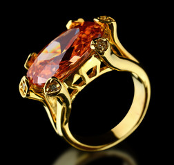 Gold ring with gem on a black © dimj