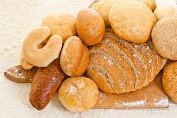 various kinds of bread on the baking board sprinkled with flour