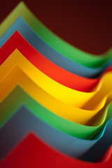 abstract colored paper structure on red background