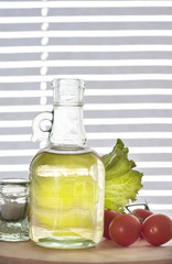 bottle of olive oil with tomato cherries