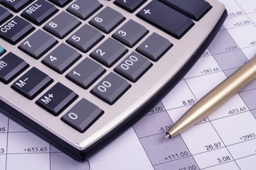 calculator and pen  on business paper