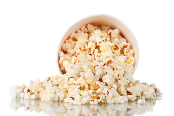 Full bucket of popcorn dropped isolated on white