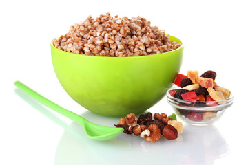 Boiled buckwheat in a green bowl isolated on white