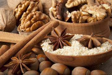 Walnut, wood nut, anise and sesame against a dark background