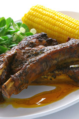 Pork ribs with corn cob and salad