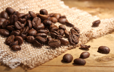 coffee beans on sacking on wooden table