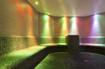 colored lights in a steam bath with long tiled bench