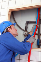 45 years old plumber connecting pipes