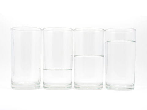 Four glasses with three level of water on white background