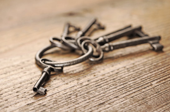 old keys on a wooden table, close-up