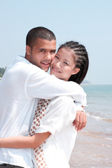 Fototapeta premium african man and asian woman lover on the beach