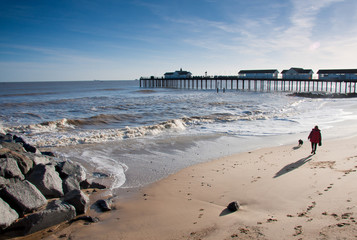 Walking on the beach, Southwold pier Suffolk